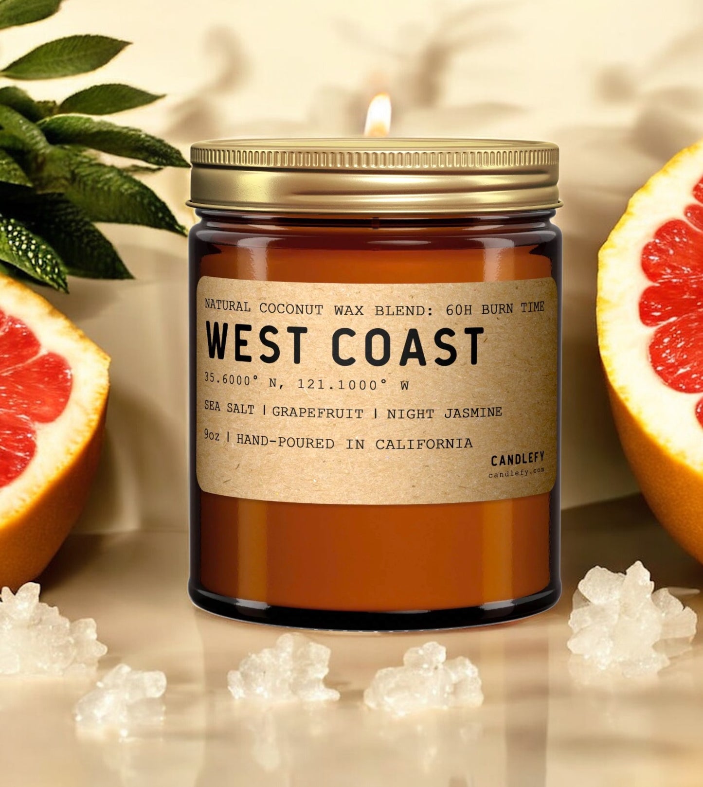 West Coast scented candle in amber jar with grapefruit, sea salt crystals, and green leaves