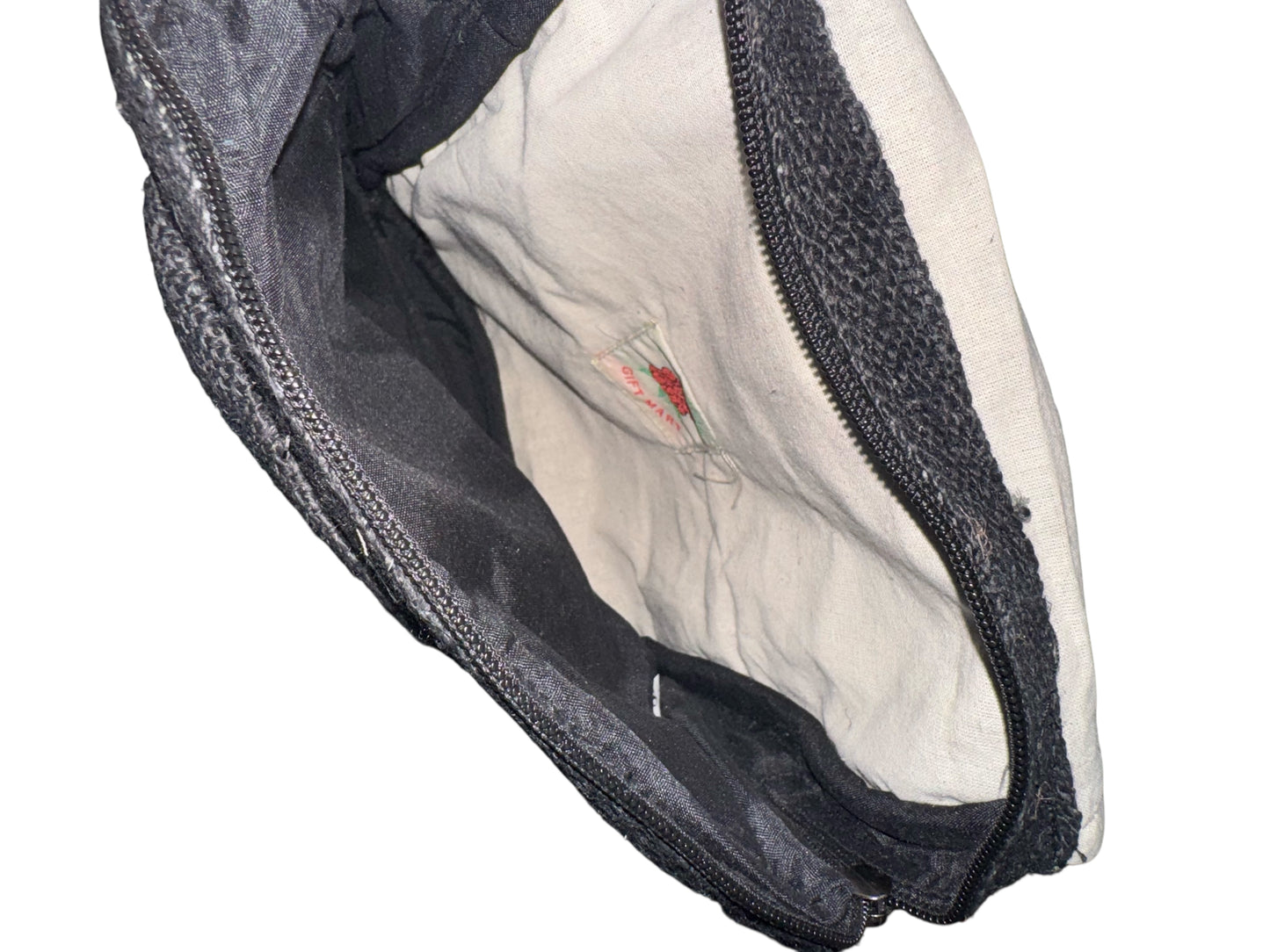 Open black and beige fabric pouch with visible label inside and black zipper closure