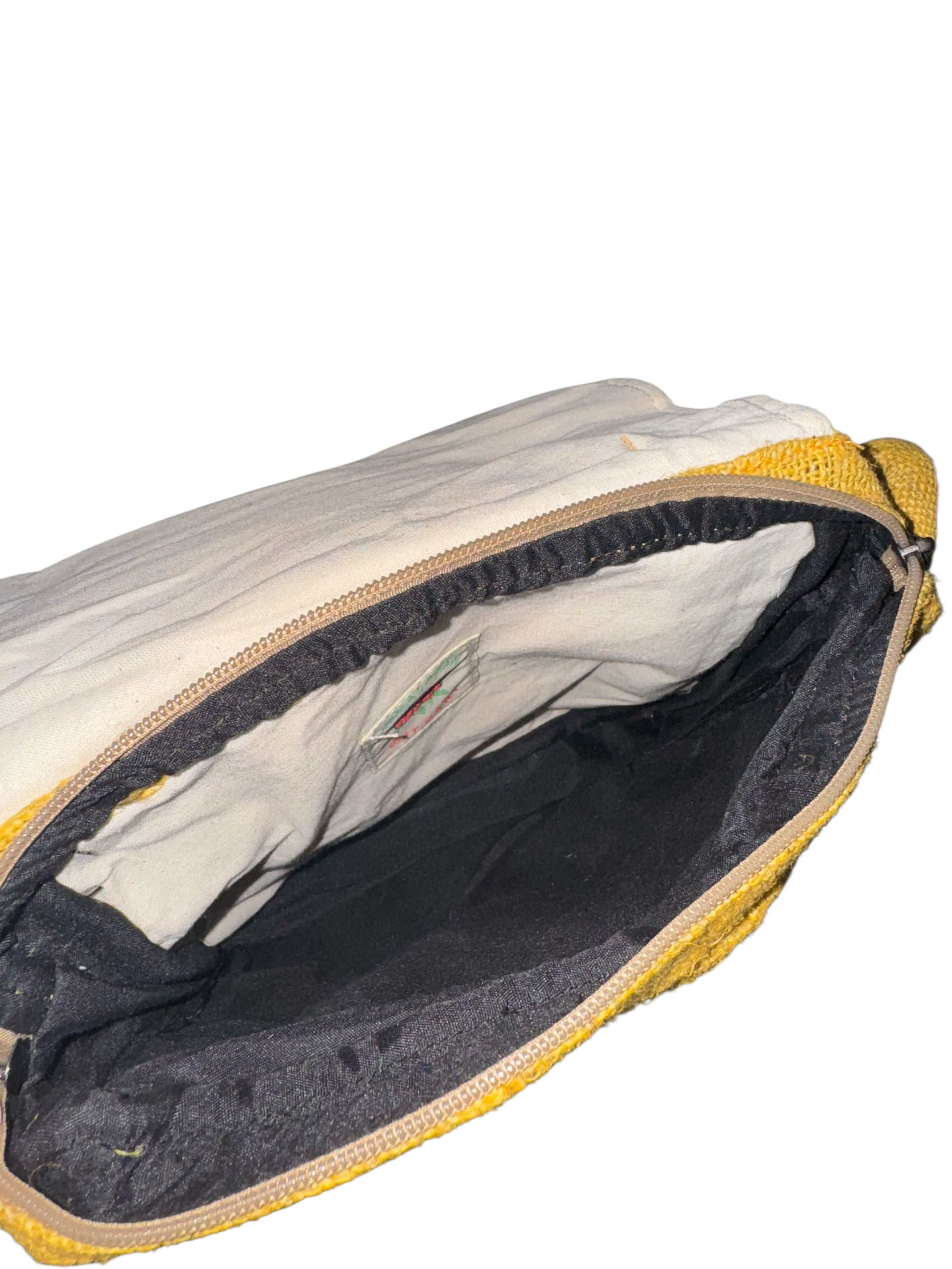 Open yellow and white fabric pouch with black interior lining and visible inner label