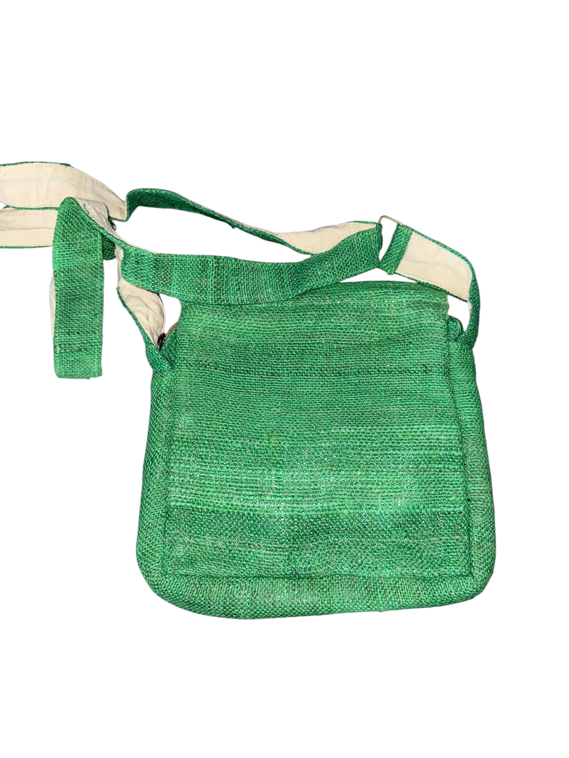 Green woven shoulder bag with adjustable beige strap on white background