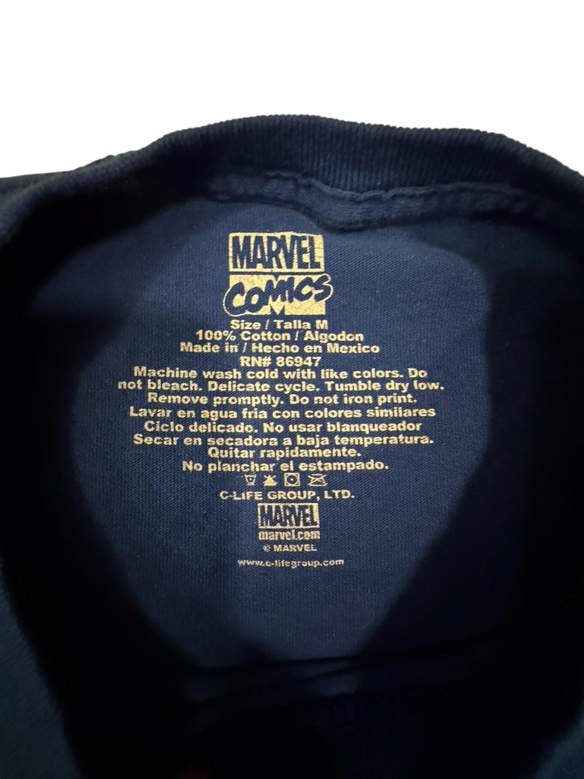 Marvel Comics navy blue cotton shirt label with size M and washing instructions in English and Spanish